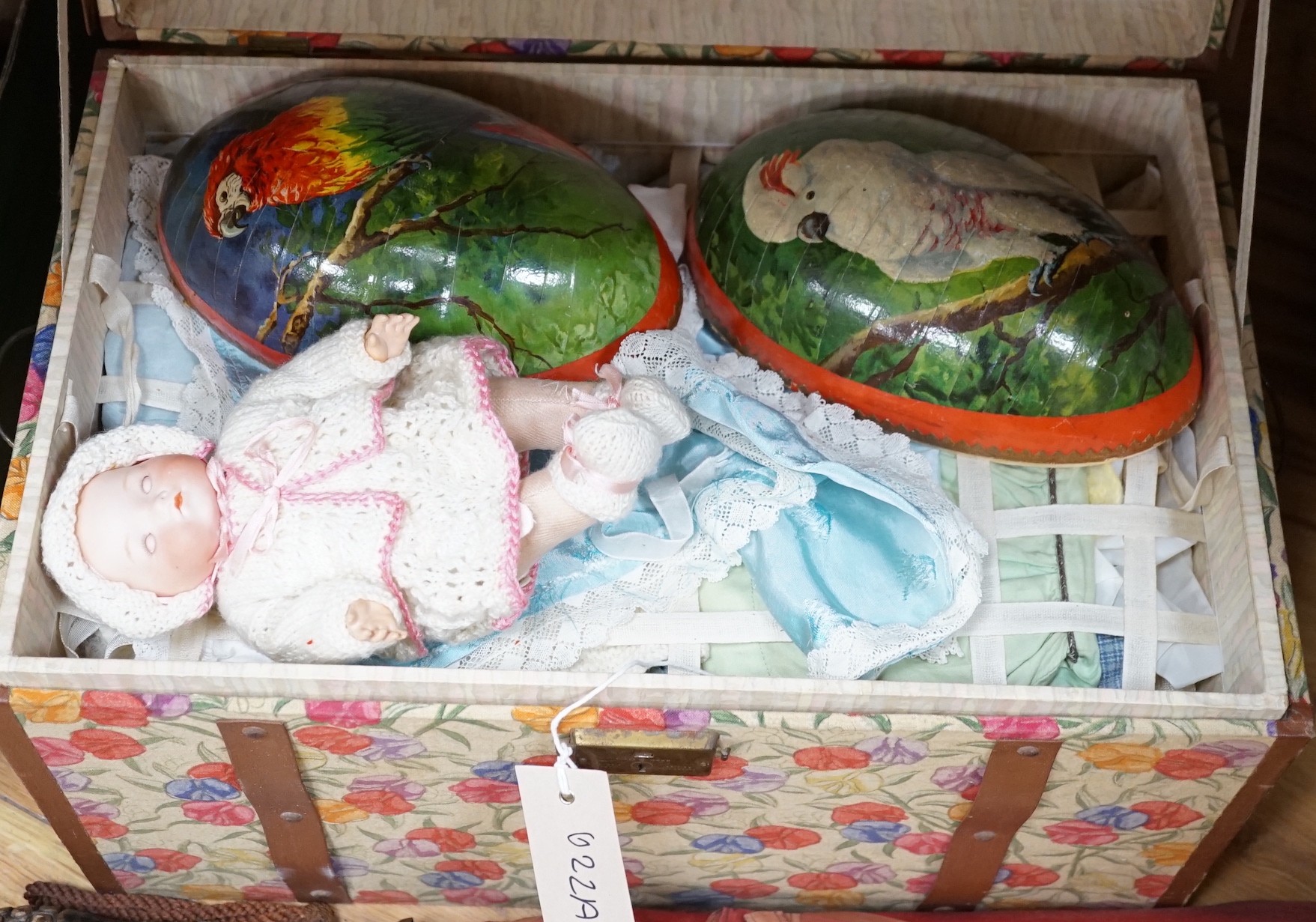 A doll's trunk containing three dolls including an Armand Marseille 341 and clothing